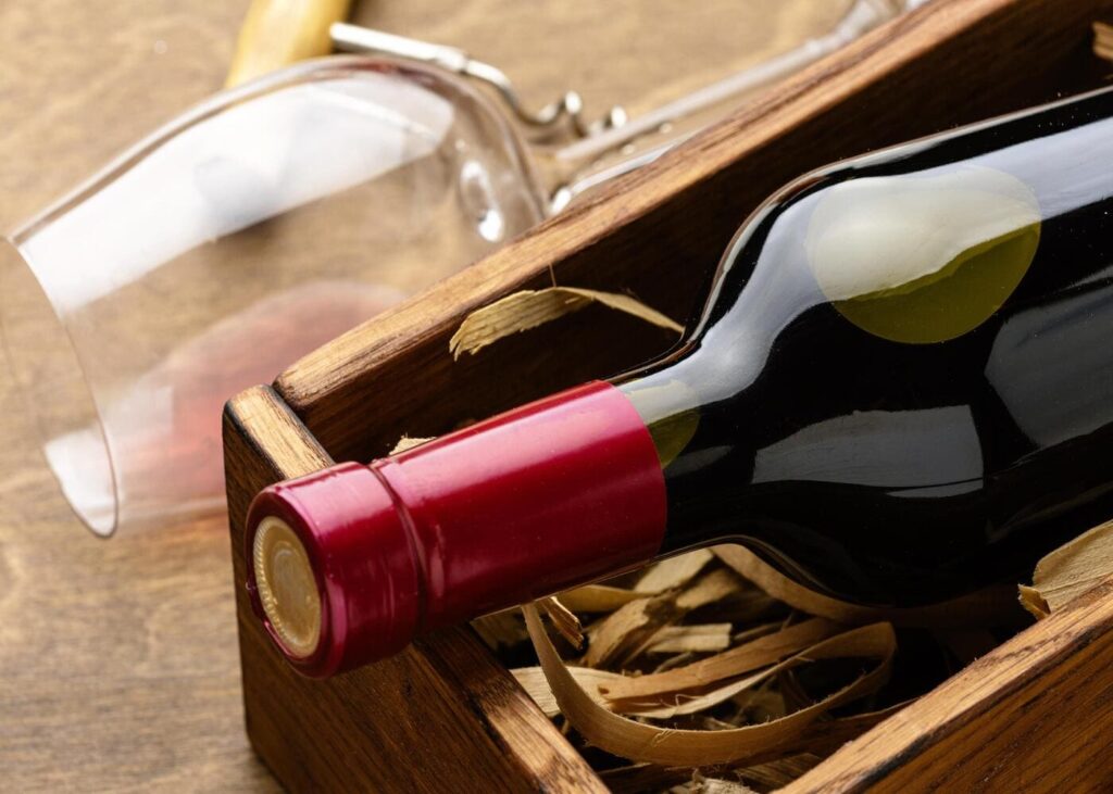primer-plano-de-una-copa-y-una-botella-de-vino-en-un-cofre