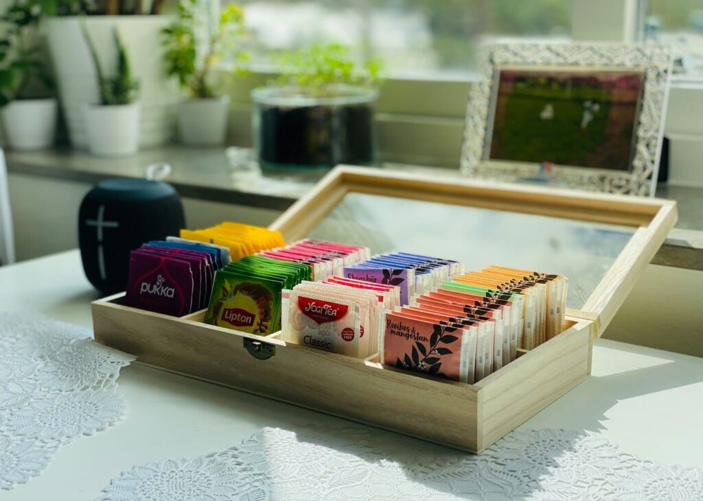 caja-abierta-con-varias-variedades-de-tés-sobre-una-mesa-de-cocina