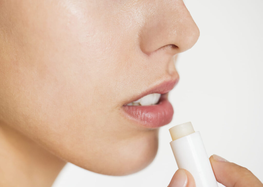 primer-plano-de-una-mujer-aplicandose-balsamo-labial